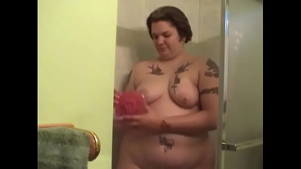 Tattooed fat chickstrips_to wash_her titsand cunt in theshower