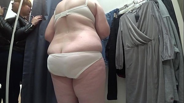 A hidden camera in the changing room peeps at a mature bbw with a big ass and natural boobs