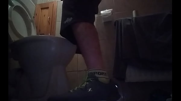 Sporty guy peeing at home