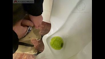 Amateur redhead guy caught pissing in a public toilet's urinal – he then quickly plays with his cock before leaving