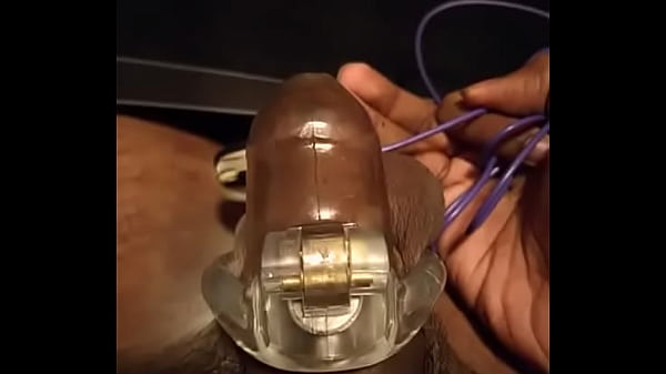 Cock vibes in cage with plug in ass