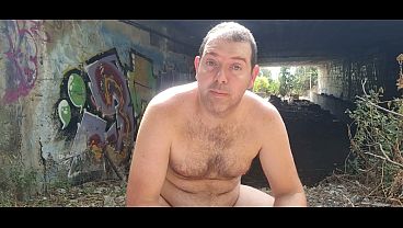 A boy completely naked near a tunnel