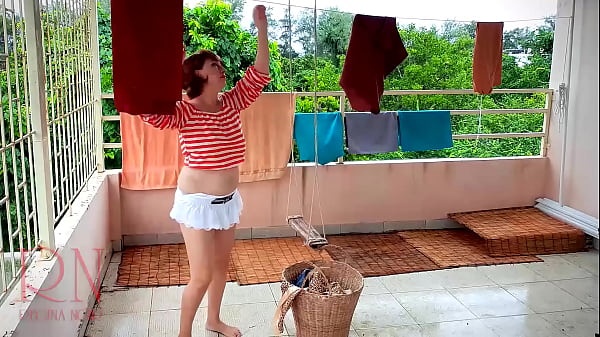 The stupid housewife hangs up the washed_laundry.