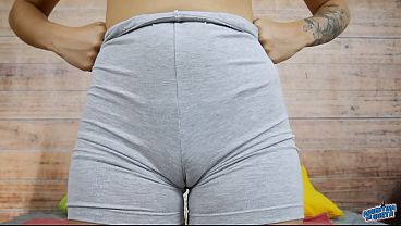 Round ass beautiful young woman wearing a g string and grey biker leggings