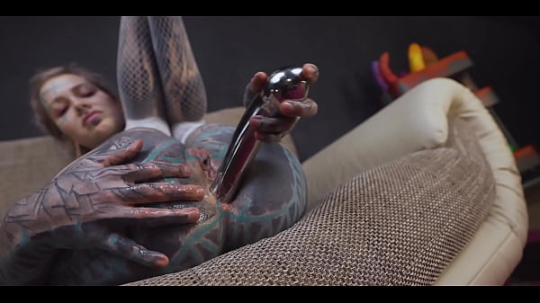 Tattoo slut sinks a thick metal toy deep into her hole 