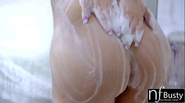 When sexy blonde Kagney Linn is soaping up her big fake tits in the shower her man can't resist 