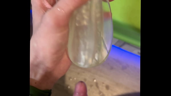 A slender, excited guy reaching orgasm from a Fleshlight toy. 