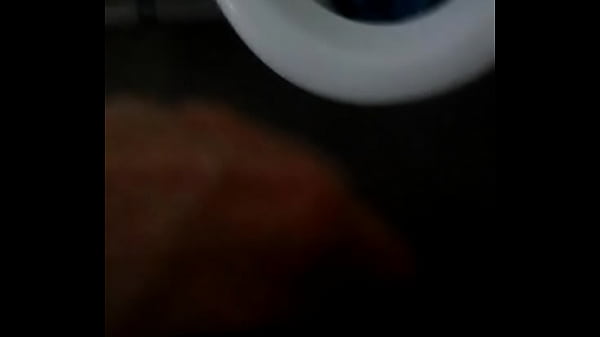 Peeing_into a porcelain urinal