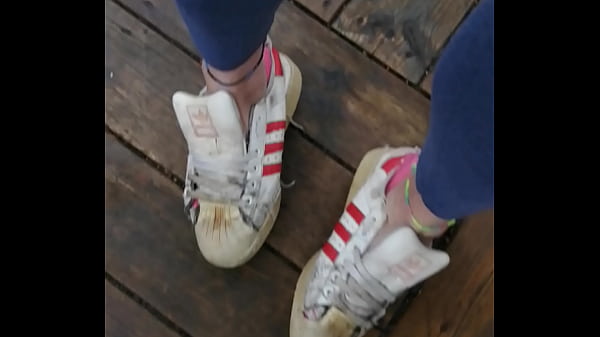 Her well worn red striped superstars