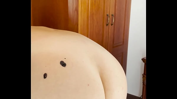 Hot wax is dripping onto my ass 