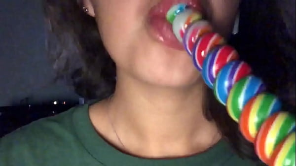 Girl eating a big lollipop 