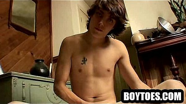 Horny hunk tugging his cock and showing off his feet 