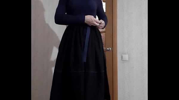 maid in a corset and niqab plays in front of the camera 