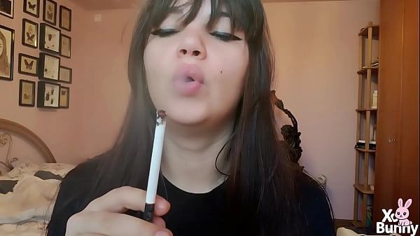 Brunette with natural big lips smoking without lip makeup 