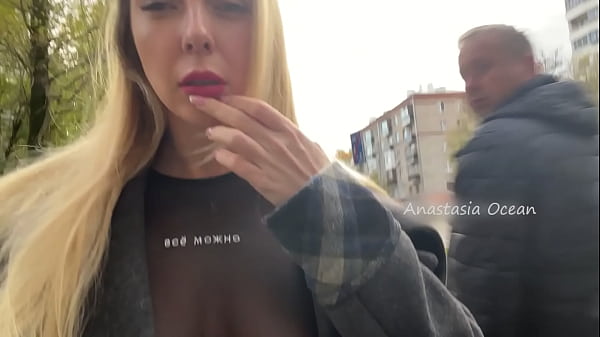 A girl showsher breasts while walking in public in_the city