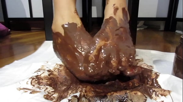 My feet with varnished nails, all covered with chocolate cream