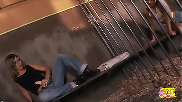 Brunette and a blonde successfully engage in sexual intercourse with a strapon while confined inside jail bars 