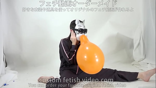 A girl_inflatesand splits a balloon