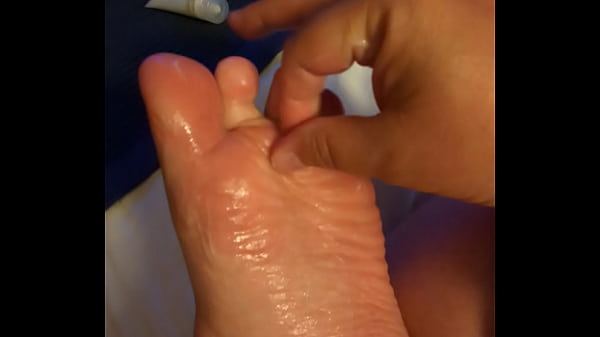 Rubbing lotion on my foot 