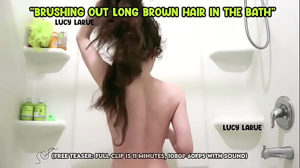 Brushing out long brown hair in the bath 