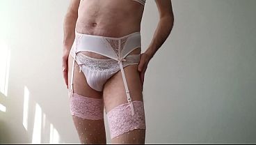 Man wearing Passionata Lingerie and putting on a garterbelt