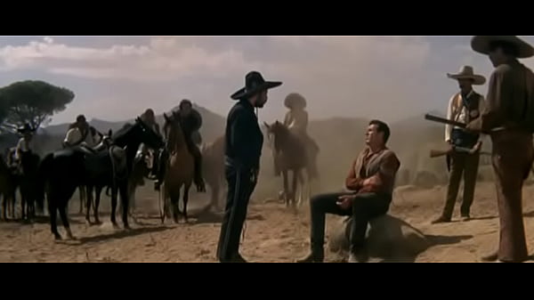 Cowboy Is Staked Out On the Ground By The Outlaw Gang. They Tie Wet Rawhide Thong Around His Throat And Left Him To His Fate Under Hot Sun. 