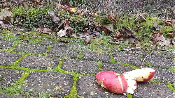 Woman crush apple underfeet 