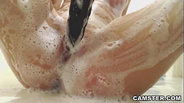 Play MP4 - Petite blonde in the shower cleaning her pussy with long black toy dildo