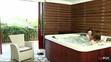 Attractive Women Engaging In Affectionate Interactions In A Jacuzzi, Play Y Spraying Water While Kissing. thumbnail