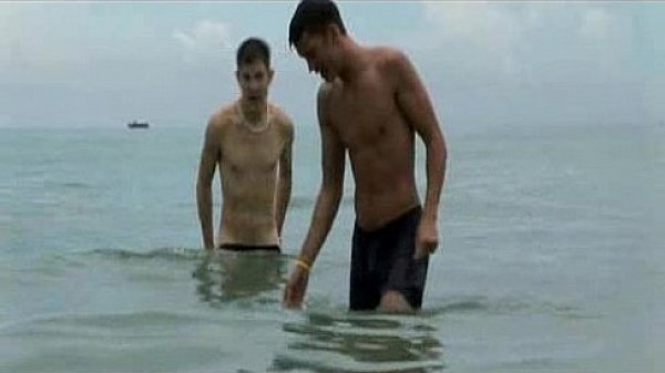 Two hunks play on the beach before jerking off 