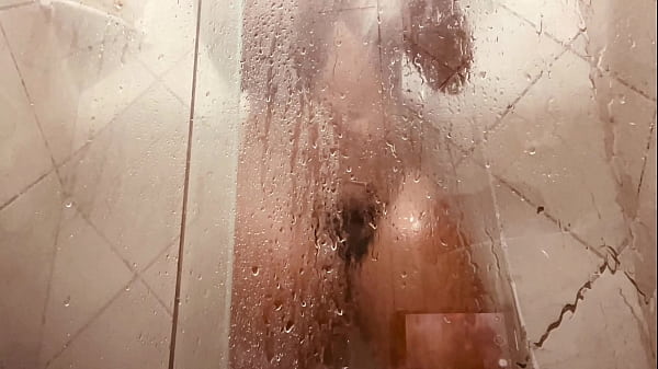 Girl being filmed while taking a shower showing off her hairy pussy 