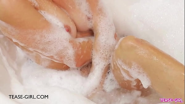 Stunning brunette beauty enjoys a sensual bath 