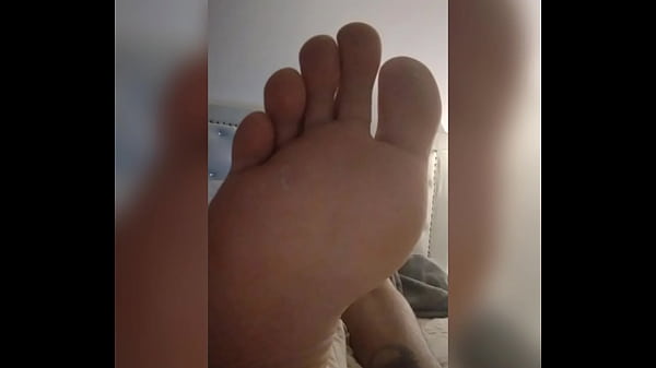 TOMAS shows his feetwhile doing_his homework