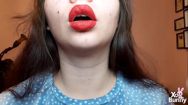 Natural lips with red lipstick smoking a cigarette in close up 