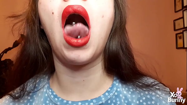 Natural lips with red lipstick smoking a cigarette in close up 