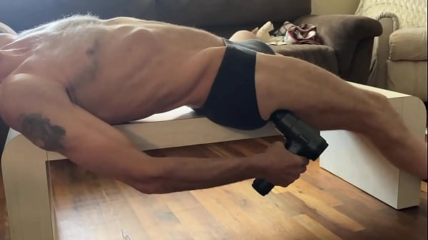Stretching on Table with Massager in underwear 