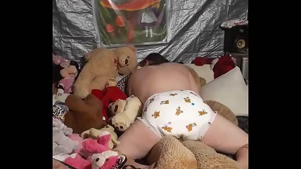 Sissy riding stuffy in a bambino diaper 