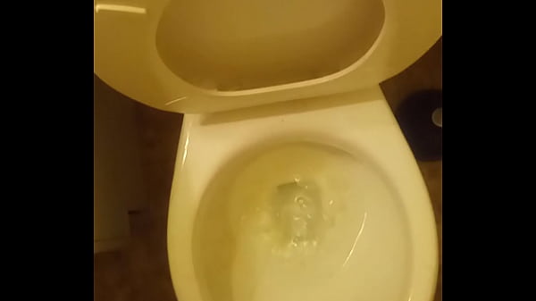 21year old takinga piss_in the toilet with a bitof penis showing