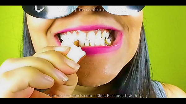 Girl with_beautiful teeth_crumpledchewed_up candychewinggum nuts to mudchew videos look her very closein her_mouth