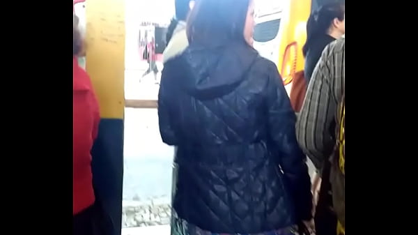 Woman in nylon jacket at the bus stop