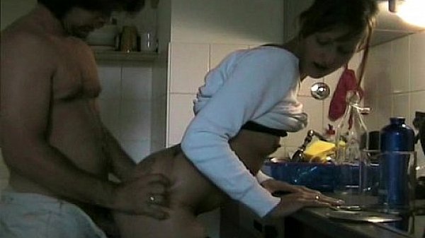 Couple having sex in kitchen 