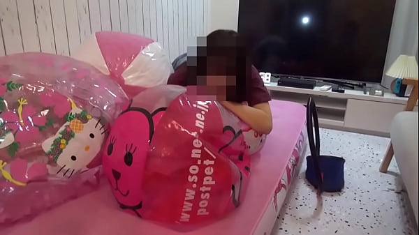 Japanese girl deflating the beachballs 