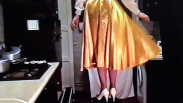 Raising her skirt to comply with his wishes 