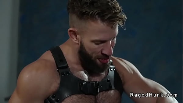 Kinky muscle gay Morgxn Thicke wearing only a harness and black boots gets blowjob from production assistant Cole Connor then fucks his hairy ass 