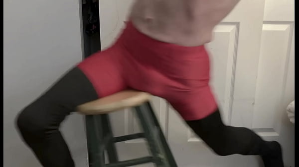 Grinding on stool in black compression tights and red compression shorts 