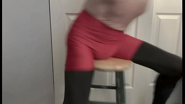 Grinding on stool in black compression tights and red compression shorts 