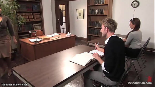 Busty brunette shemale girl Deanna seduces her colleague Dean Strong during exam and then anal fucks him while he is wanking cock on the desk 