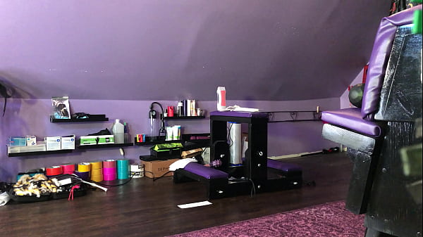 Dominatrix waxing man;s legs 