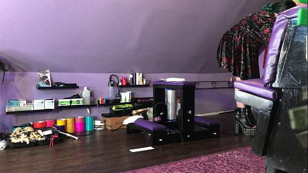 Dominatrix waxing man;s legs 