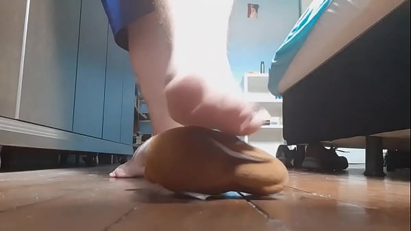 Bare feet stepping very tasty on a teddy bear 